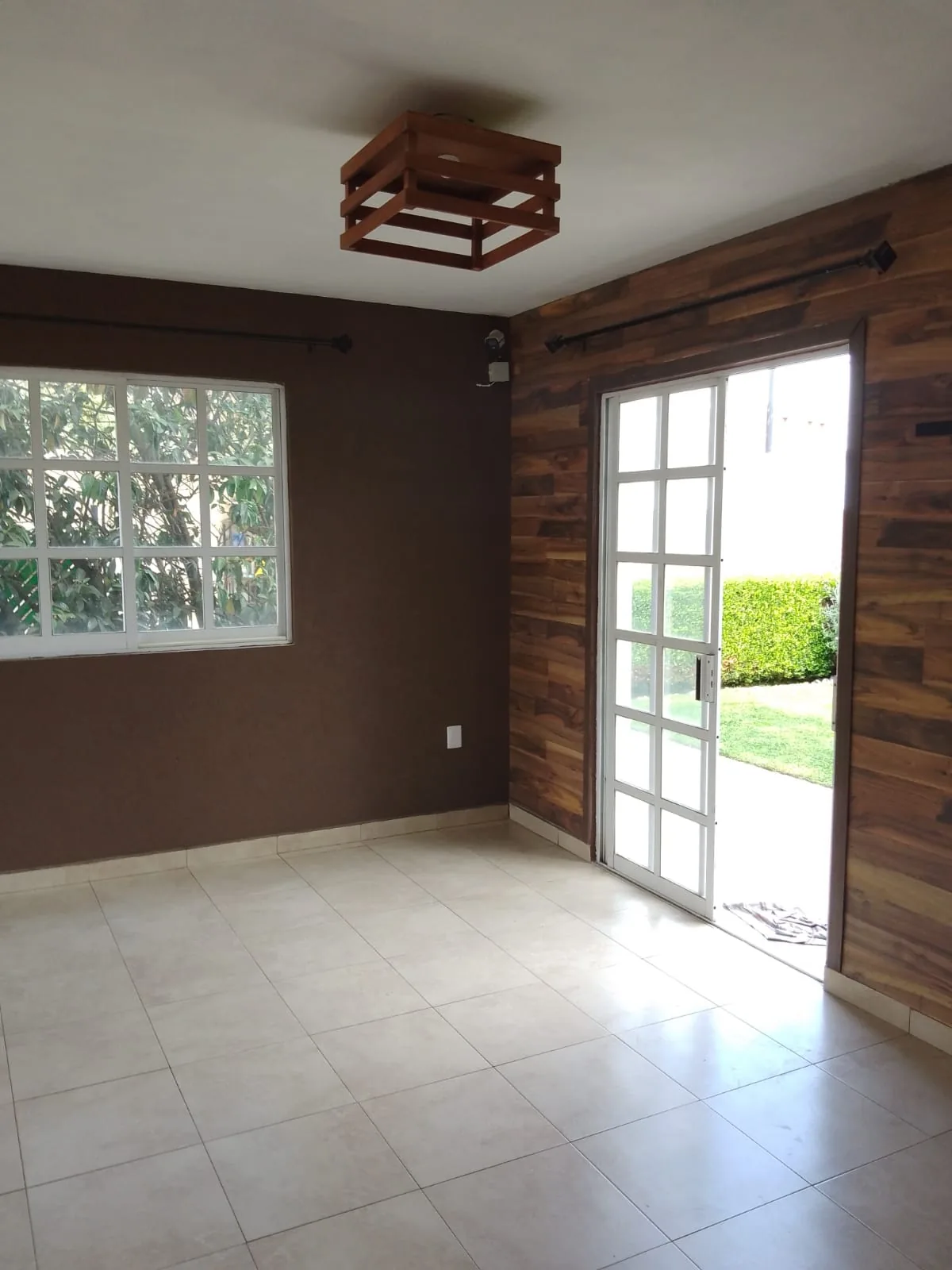 Comedor con muro de madera y salida directa al jardín
